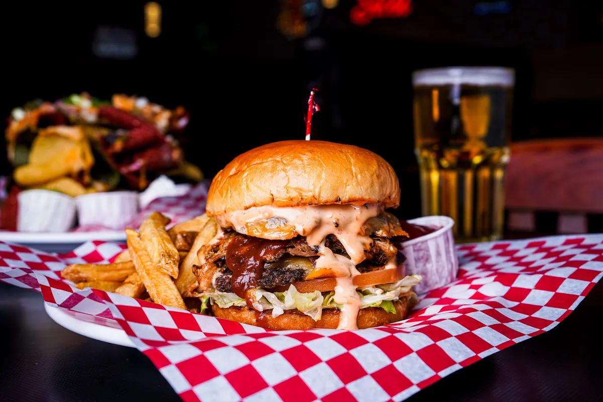 Large burger with fries and a drink